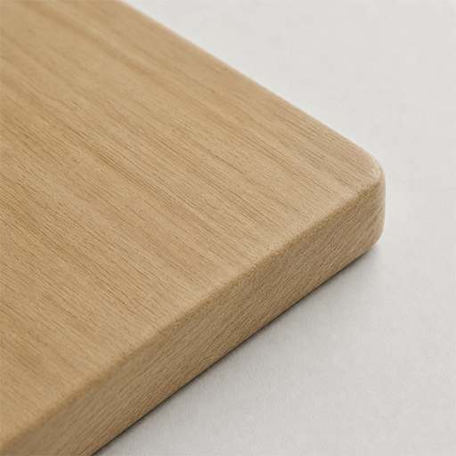 Swatch of a warm brown wood finish with a fine natural grain, shown as a rounded-edge sample block
